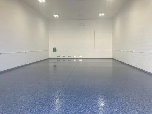 Finished garage condo bay with blue epoxy floor
