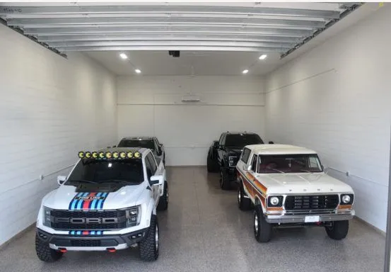 Garage condo bay with trucks and epoxy flooring