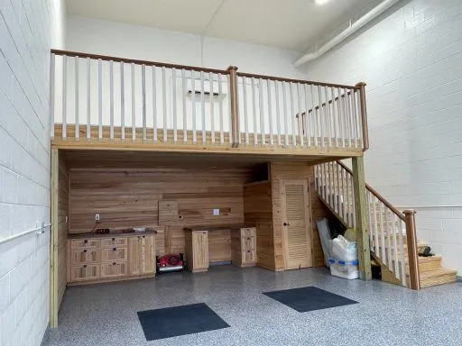 Garage condo interior with custom wood loft and cabinetry
