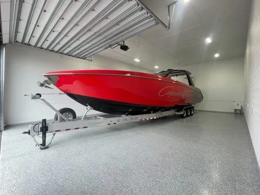 Garage condo bay with red performance boat on trailer